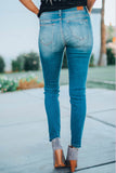 Jeans skinny distrutti con toppe scozzesi