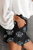 Pantaloncini in vita elasticizzati con stampa foglie di palma e tasca