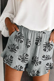 Pantaloncini in vita elasticizzati con stampa foglie di palma e tasca