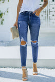 Jeans skinny strappati a vita alta